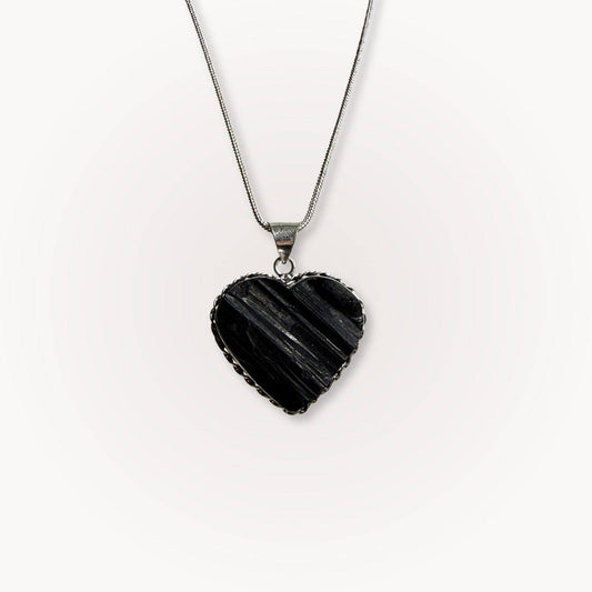Black Tourmaline Heart Pendant on silver chain, ideal for protection and grounding. Features raw crystal texture in heart shape for spiritual balance.