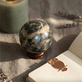 Soulful Black Moonstone Sphere with shimmering surface on wooden stand, ideal for intuition and meditation rituals in crystal healing collections.