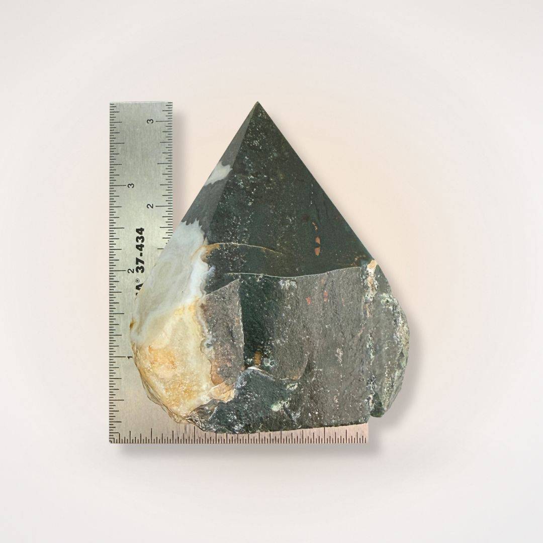 Bloodstone tower with ruler for scale, 250-300g weight, showcasing polished point and raw base for grounding and transformation rituals.