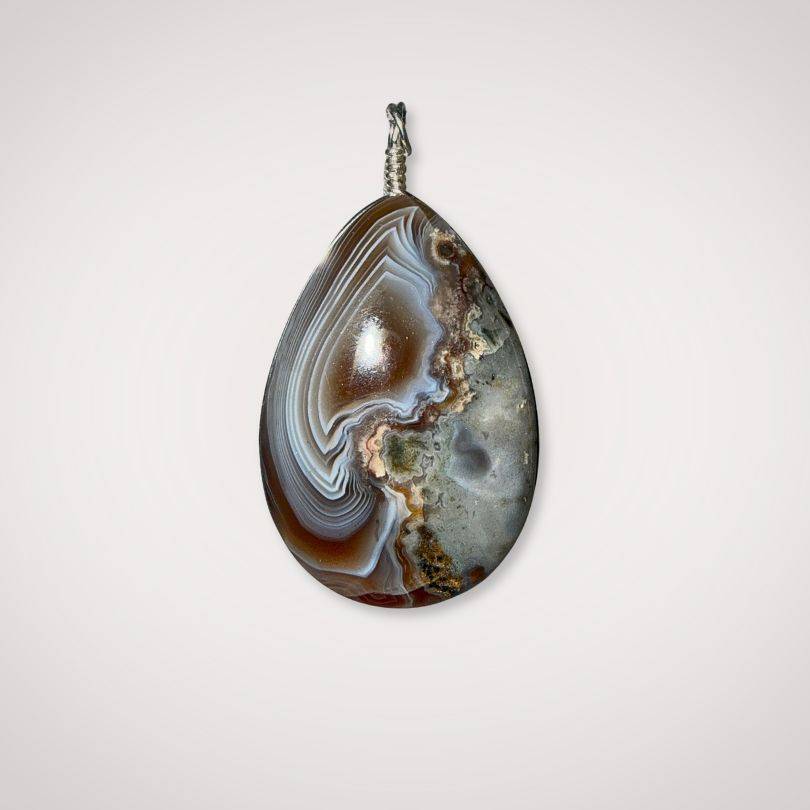 Botswana Agate pendant with parallax ghost effect on white background