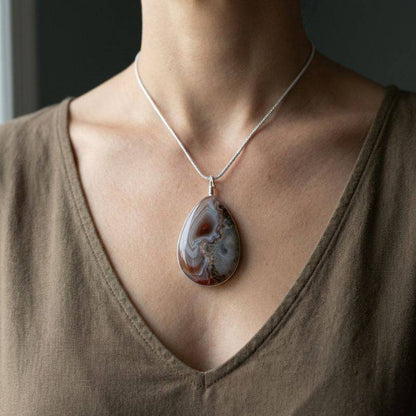 Woman wearing Botswana Agate pendant with silver chain