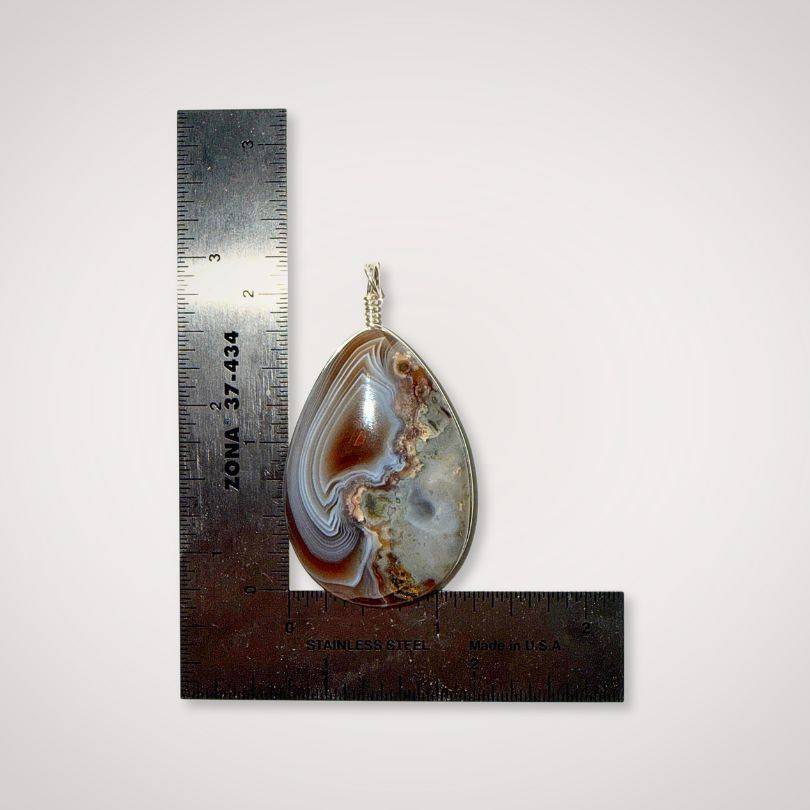 Botswana Agate pendant with parallax ghost effect and polished surface scale view