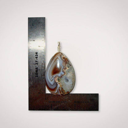 Botswana Agate pendant with parallax ghost effect and polished surface scale view