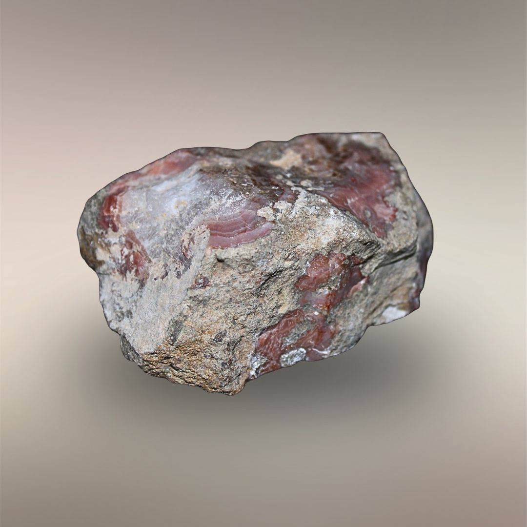 Bou Hamza Agate host-free nodule exterior from Al Hama, Morocco with exposed rose agate and natural rind.