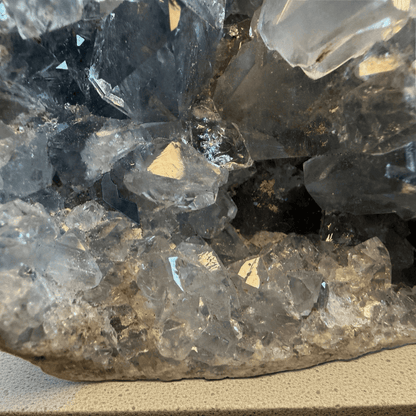 Close up view of Celestite Geode with sparkling blue crystal points, natural formation