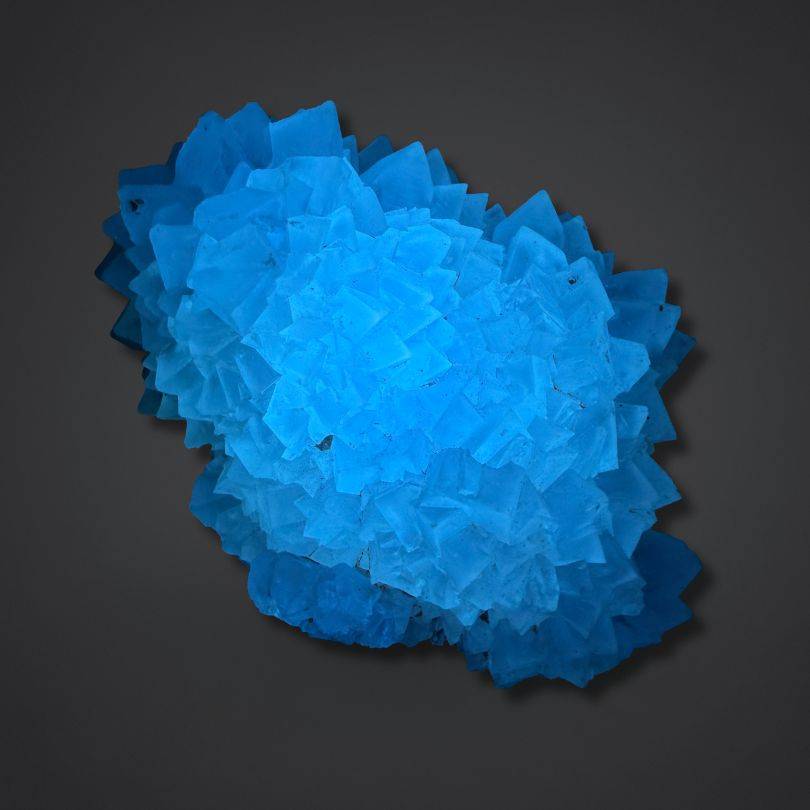 Blue fluorescent calcite specimen with vibrant glow, India