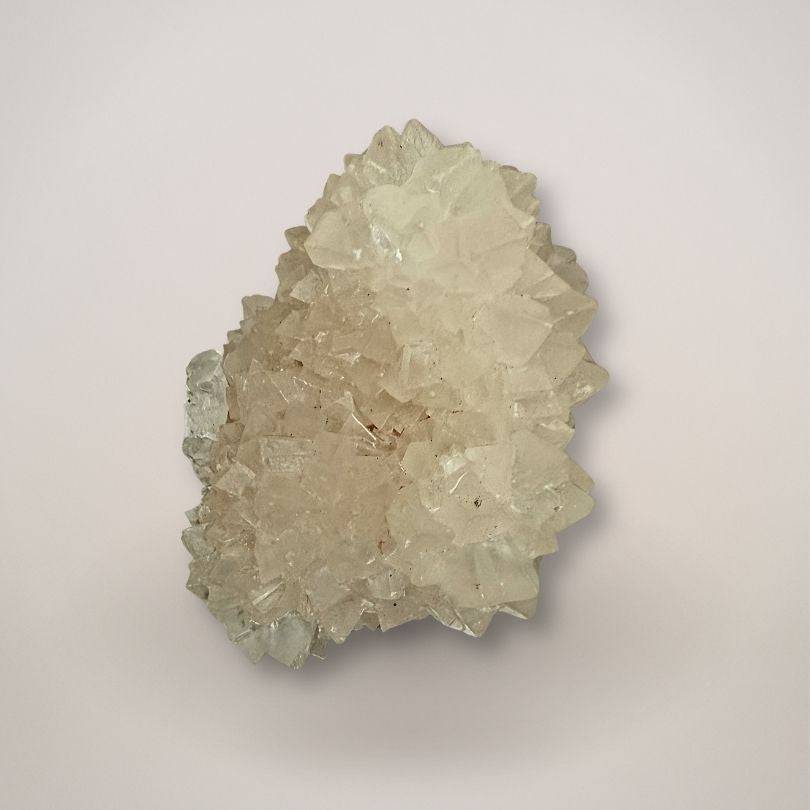 Large fluorescent pinecone calcite cluster with phosphorescent glow, India
