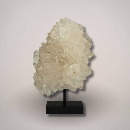 White calcite mineral specimen on display stand, India