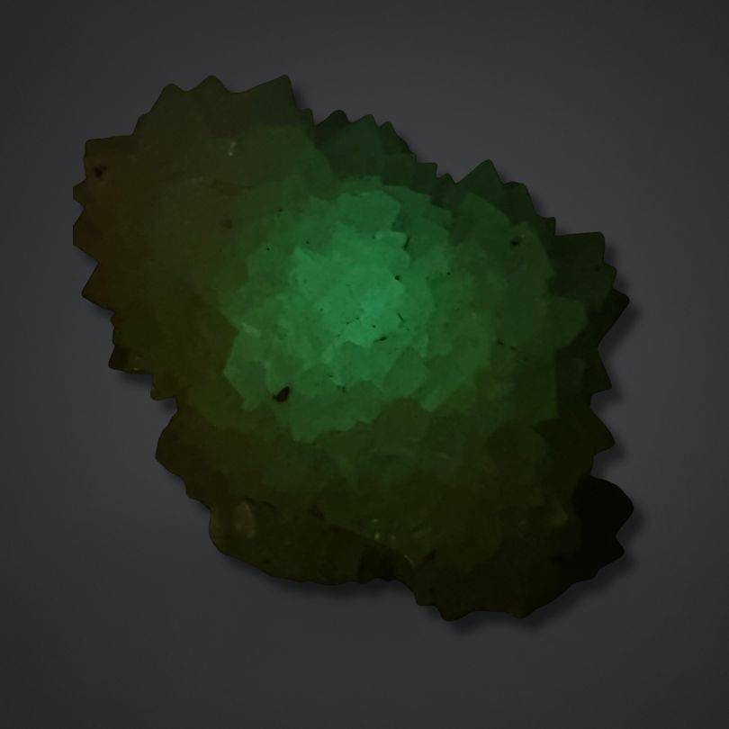 Green phosphorescent glow calcite mineral with sculptural pinecone shape, India