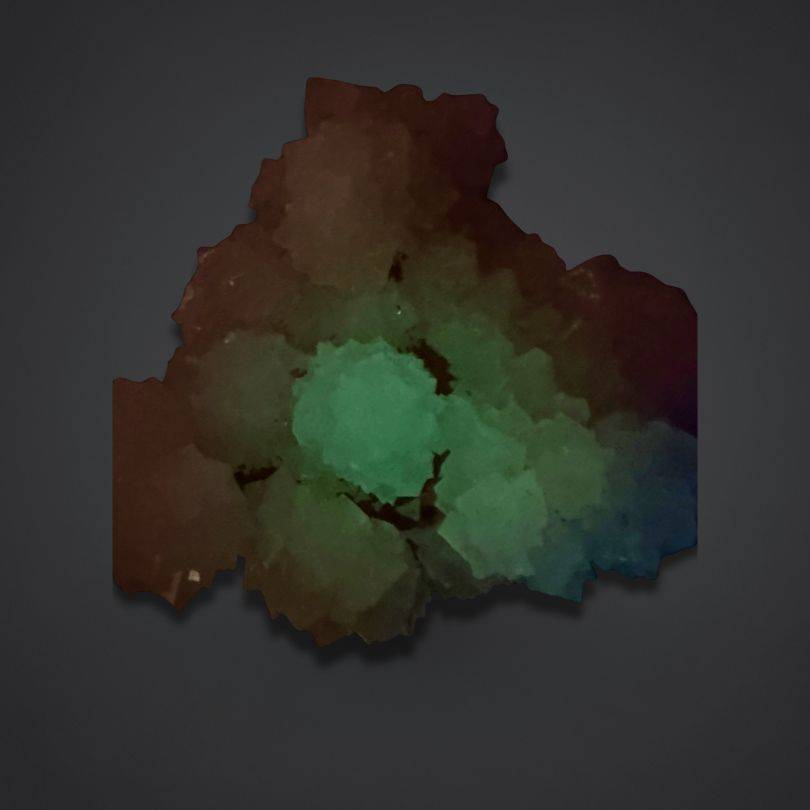 white calcite mineral specimen India with green phosphorescent glow