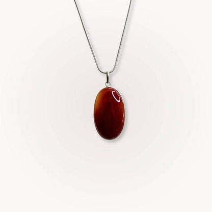 Carnelian Statement Pendant with deep red-orange crystal on a silver chain, designed to boost confidence and vitality. Ideal for crystal jewelry lovers.