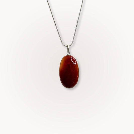 Carnelian Statement Pendant with deep red-orange crystal on a silver chain, designed to boost confidence and vitality. Ideal for crystal jewelry lovers.