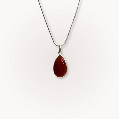 Carnelian Classic Pendant with teardrop shape on silver chain, showcasing warm red-orange crystal for confidence and vitality.