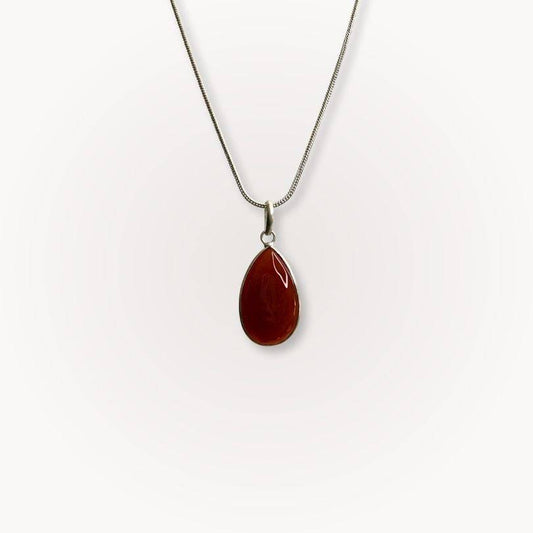 Carnelian Classic Pendant with teardrop shape on silver chain, showcasing warm red-orange crystal for confidence and vitality.