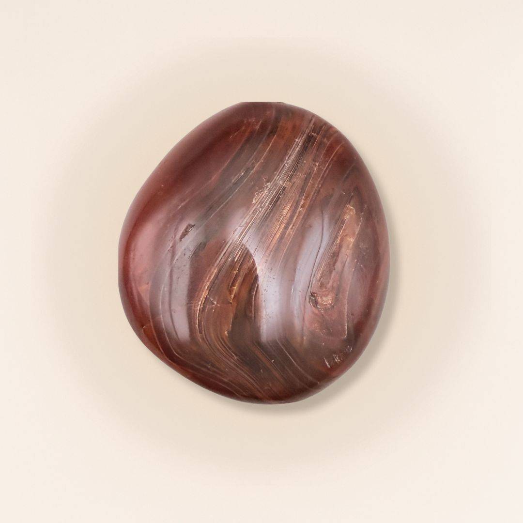 Carnelian Tumbled Stone with rich red and brown hues, ideal for enhancing creativity and courage in home decor or energy practices.