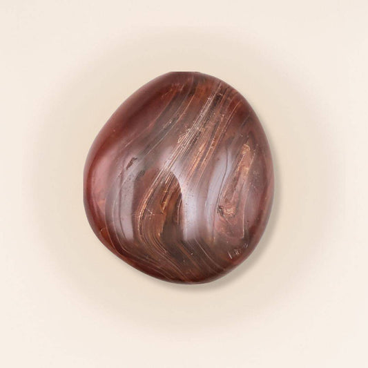 Carnelian Tumbled Stone with rich red and brown hues, ideal for enhancing creativity and courage in home decor or energy practices.