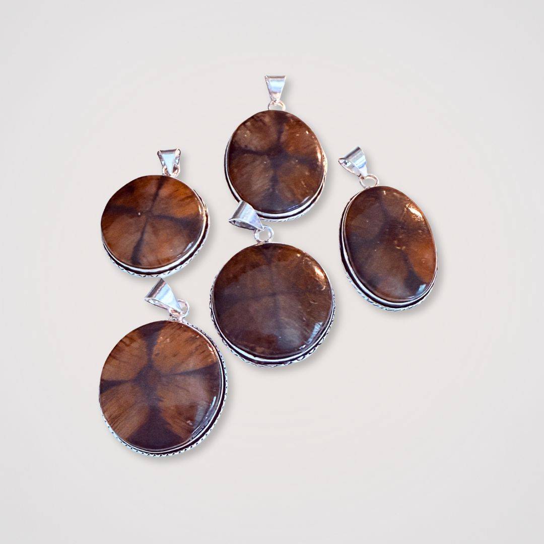 Chiastolite Cross Stone Pendants in round and oval shapes with silver bezels, ideal as protection talismans and grounding jewelry pieces.