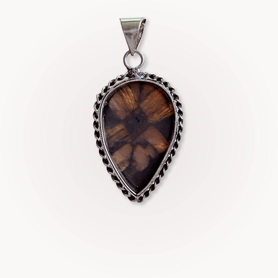 Detailed view of teardrop Chiastolite Cross Stone Pendant with silver edging, showcasing the natural cross symbol for protection and grounding.
