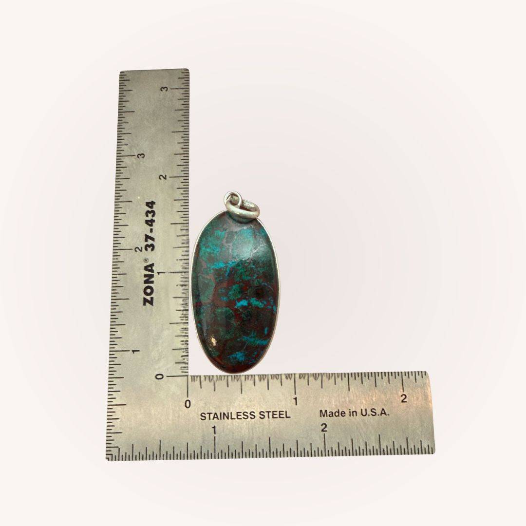 Oval Chrysocolla Pendant for Calm & Heart Healing by Mystic Parcel shown with ruler for scale, featuring green and copper gemstone.