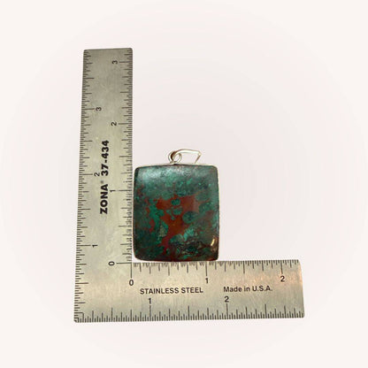 Square Chrysocolla Pendant for Calm & Heart Healing by Mystic Parcel shown with ruler for size reference, featuring green and copper hues.