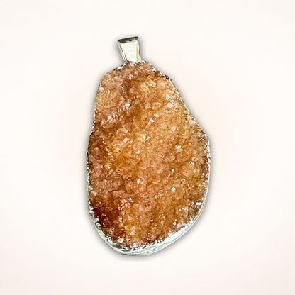 Oval-shaped Brazil Citrine Drusy Cluster Pendant in .925 Silver Bezel featuring light orange druzy crystals and smooth silver bail.