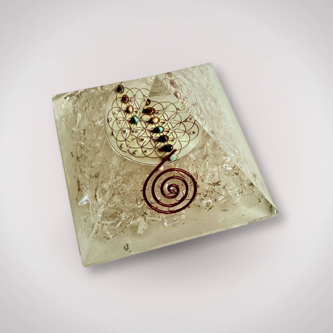 Top view of Clear Quartz Flower of Life Orgonite Pyramid showcasing chakra alignment stones and intricate copper spiral design.