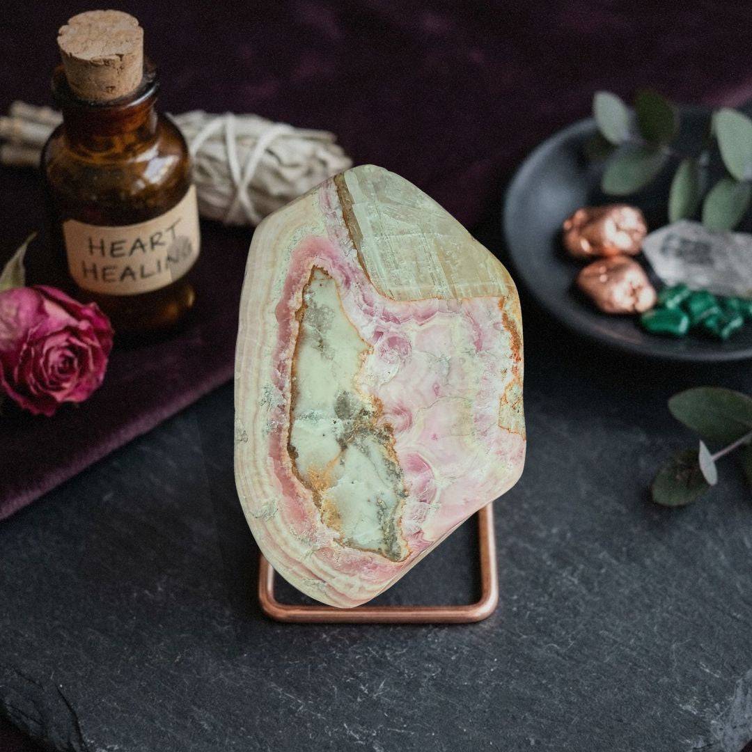 Cobaltoan Calcite specimen on display stand for emotional renewal