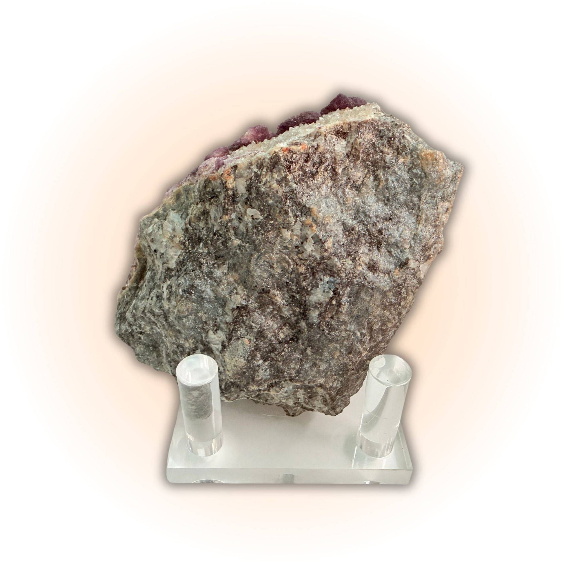 Backside of Deep Violet Botryoidal Fluorite Crystals Specimen on display stand, revealing raw stone matrix and natural texture.