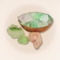 Assorted fluorite raw pieces in a copper bowl, showcasing green, purple, and pink hues. Perfect for collectors and intuitive energy work.