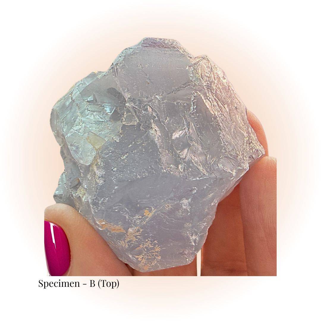 Brazilian Purple Fluorite crystal specimen B held by hand, showcasing raw translucent texture and soft violet hues for clarity and focus.