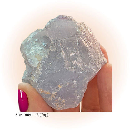 Brazilian Purple Fluorite crystal specimen B held by hand, showcasing raw translucent texture and soft violet hues for clarity and focus.