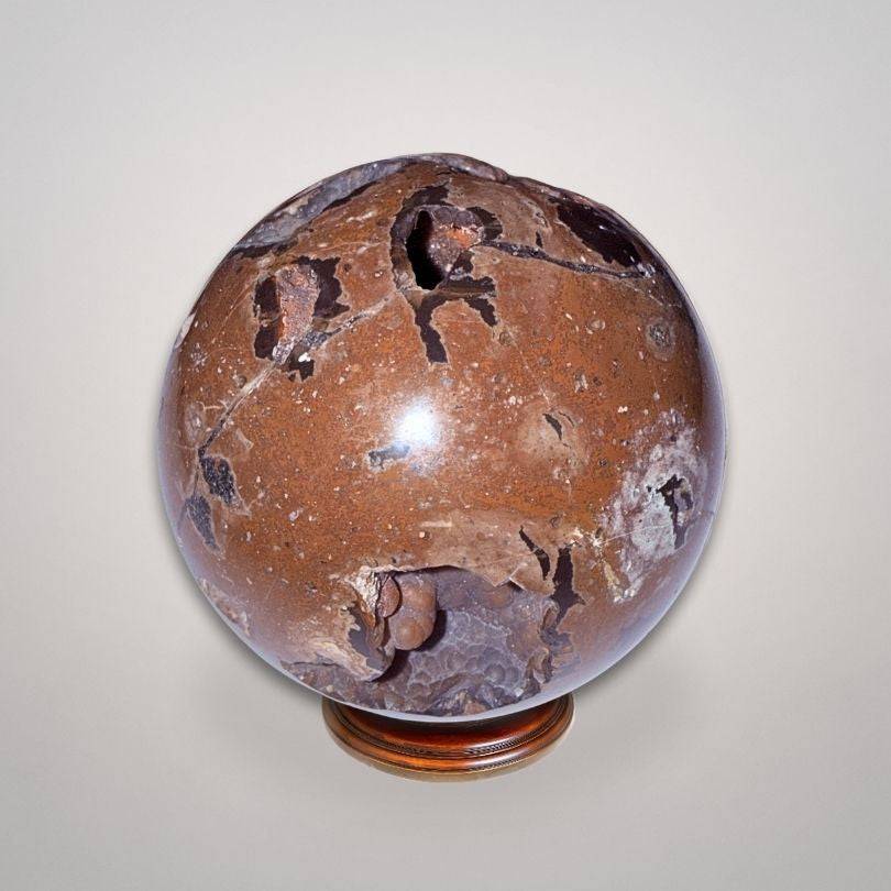 Back view of polished Red Fox Agate Sphere (346g) with visible mineral textures and hematite-lined voids, ideal for grounding and protection rituals.