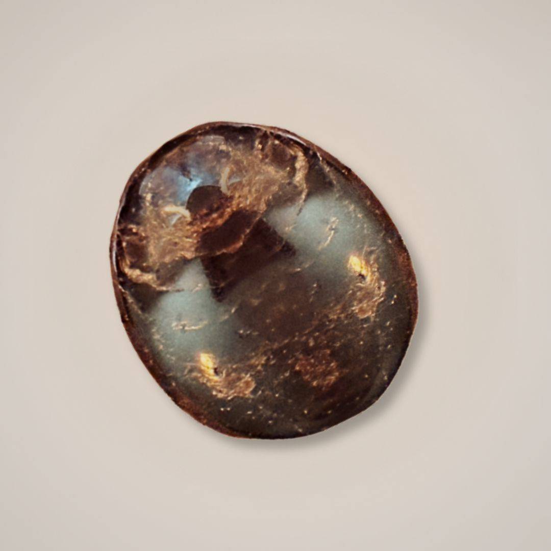 Close up view of garnet palm stone showing natural patterns and color