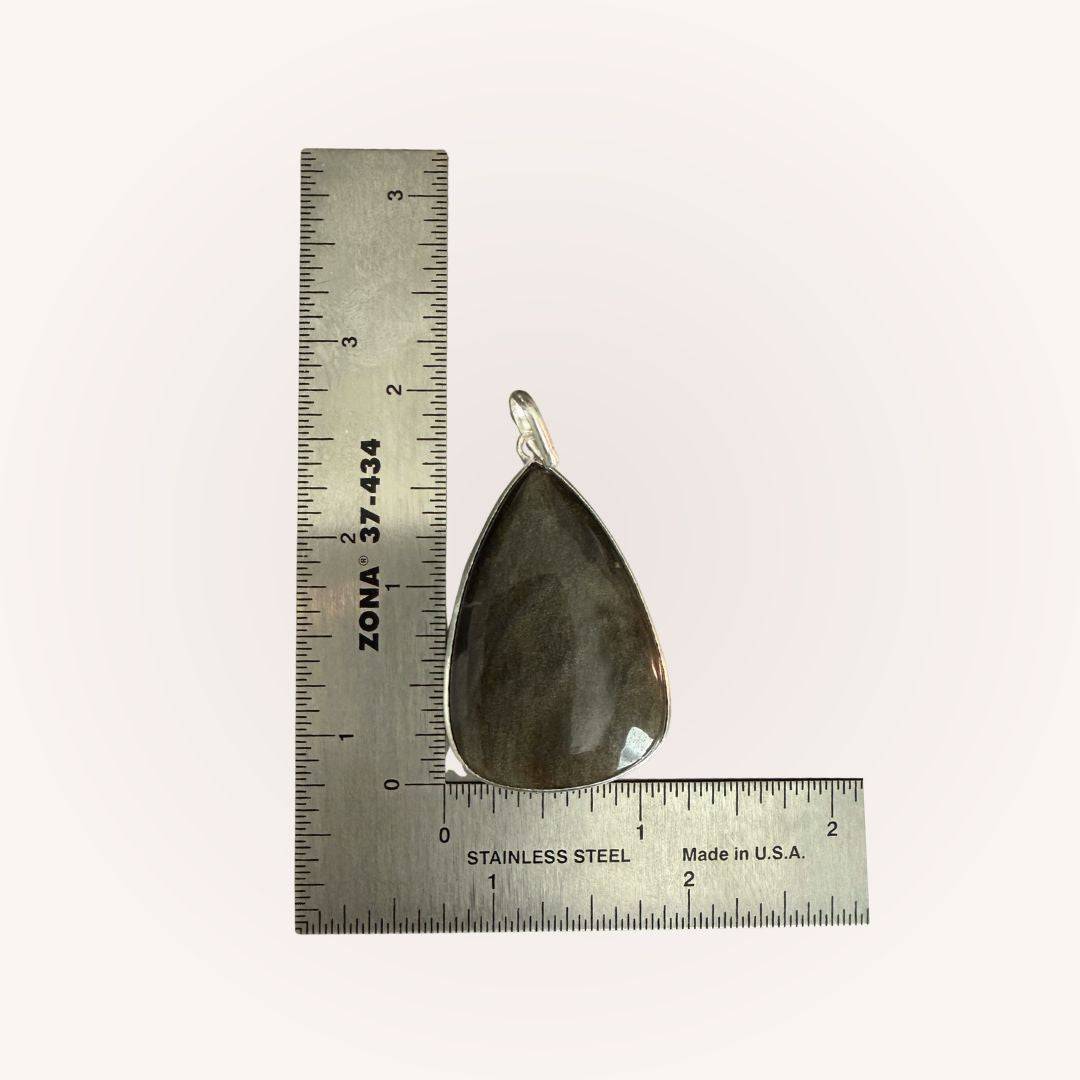 Teardrop Gold Sheen Obsidian Pendant next to ruler for size reference. Empowering jewelry piece for shadow work and spiritual clarity.