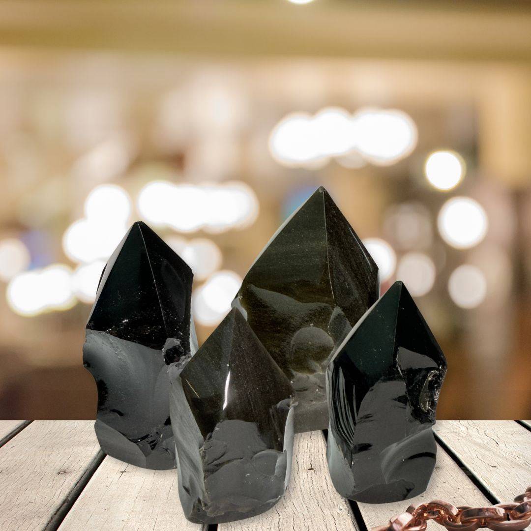 Set of three Gold Sheen Obsidian Generators with top polish and natural sides displayed on wooden surface, perfect for shadow work and energy healing.