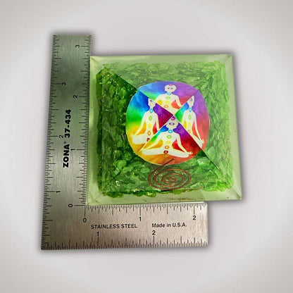 Green Quartz Chakra Orgonite Pyramid next to ruler for scale, showcasing artisan detail and compact size for spiritual home decor.