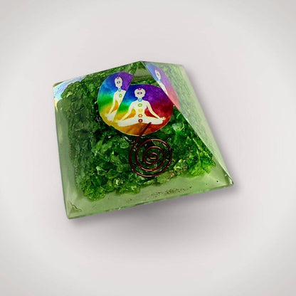 Handcrafted Green Quartz Orgonite Pyramid featuring chakra symbol and copper spiral, perfect for mindful rituals and energy balance.