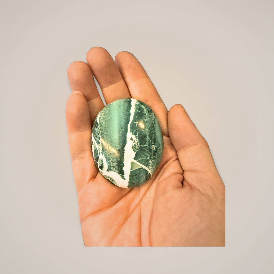 Green Zebra Jasper palm stone in hand for energy work