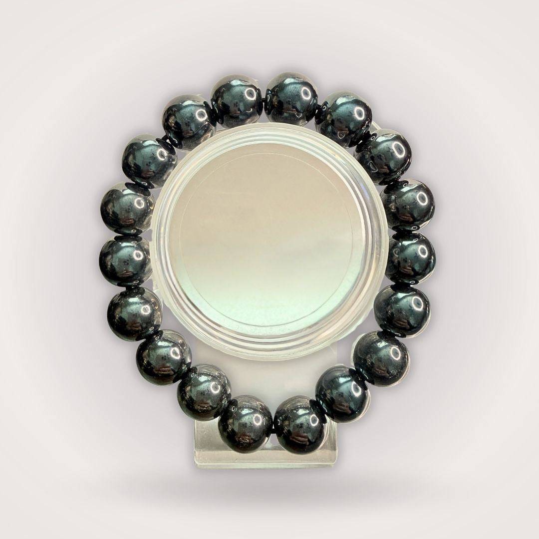 Hematite 12mm Beaded Bracelet - Grounding & Stable Protective accessory featuring polished black natural stone beads in a circular display.