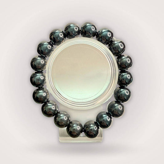 Hematite 12mm Beaded Bracelet - Grounding & Stable Protective accessory featuring polished black natural stone beads in a circular display.