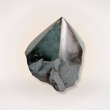 Hematite top polish natural sided point tower with a glossy finish and raw base, ideal for grounding and focus in mineral collections.