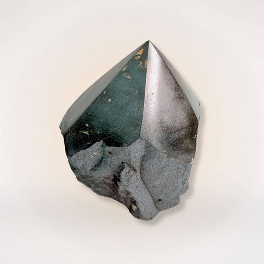 Hematite top polish natural sided point tower with a glossy finish and raw base, ideal for grounding and focus in mineral collections.
