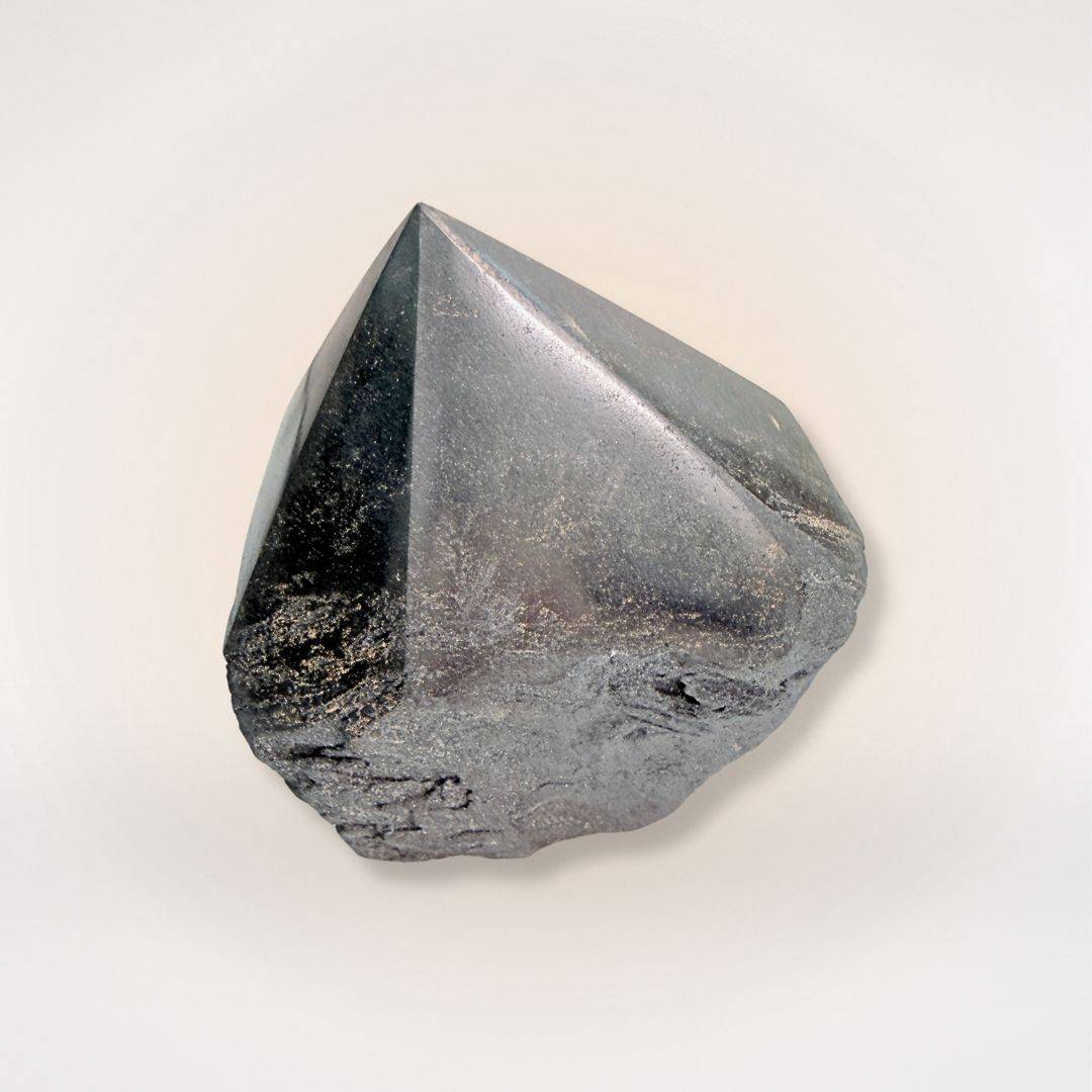 Polished hematite point tower featuring a sleek, reflective surface and raw stone base, perfect for mental clarity and mineral enthusiasts.