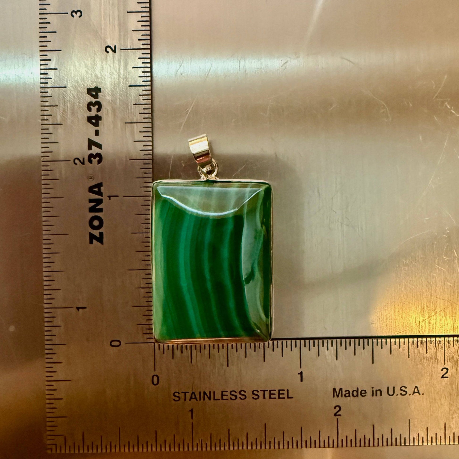 Size Large  60ct - natural malachite pendant with silver bale, high-polish front, placed beside a stainless steel ruler for size reference.