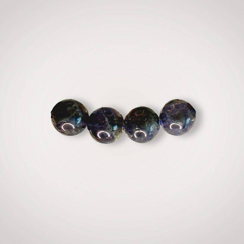 Close-up of four 8mm Iolite beads showing natural variations in color and clarity, ideal for enhancing inner vision and focus.