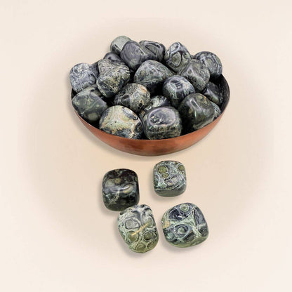 Bowl filled with Kambaba Jasper Cube Stones - Tumbled, featuring polished green-black stones for grounding energy and spiritual wisdom.