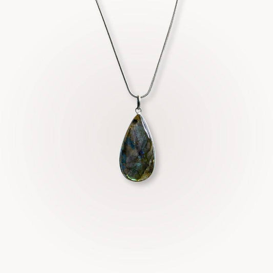 Labradorite Statement Pendant with blue flash on silver chain, designed for intuition and protection in jewelry collections.