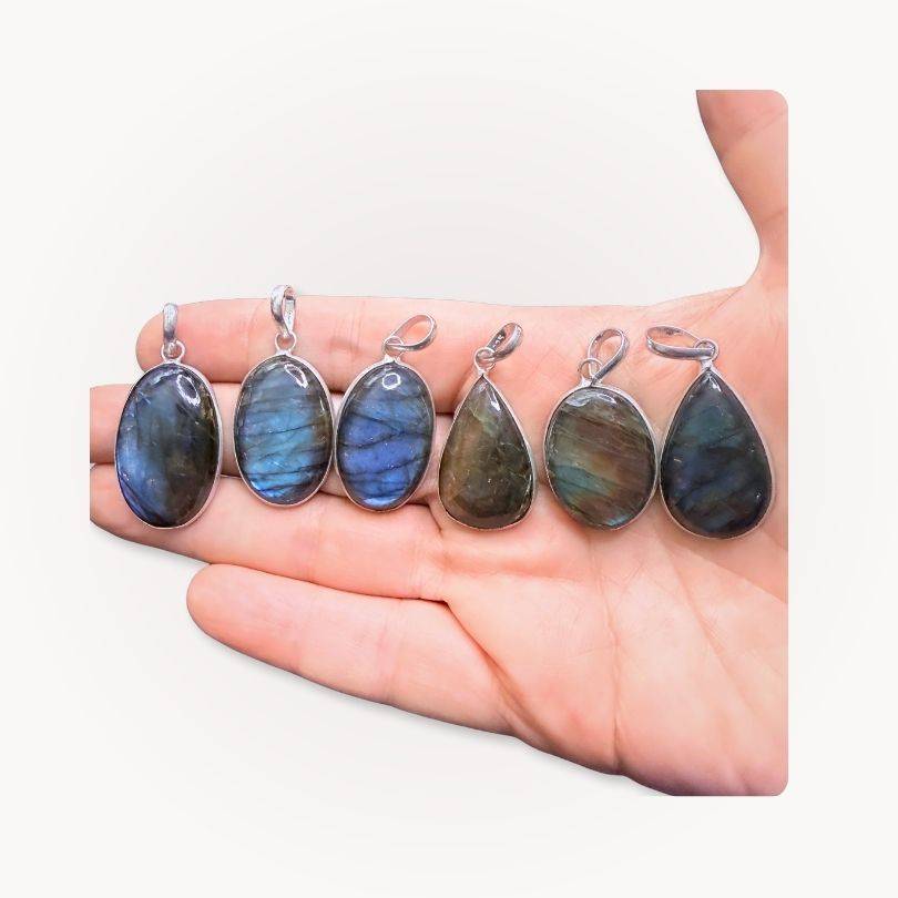 Assorted Labradorite Classic Pendants displayed on hand, each with unique blue flash, ideal for spiritual clarity and protection.