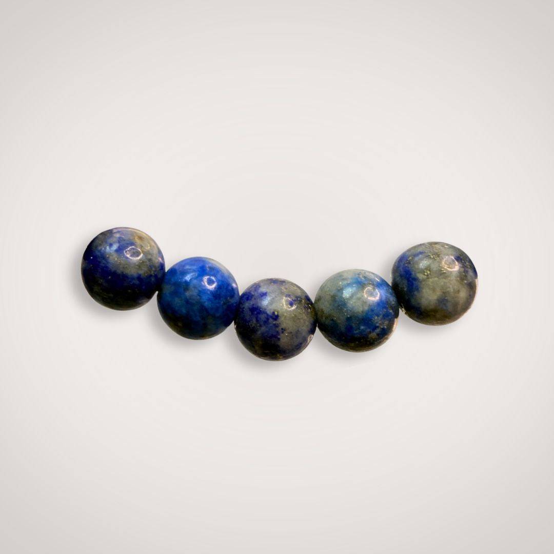 Close-up of five Lapis Lazuli 6mm beads, emphasizing natural blue tones and quality craftsmanship for intuition and wisdom.