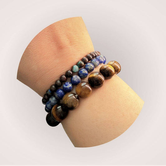 Lapis Lazuli 8mm Beaded Bracelet stacked with other gemstone bracelets on wrist, highlighting its vibrant blue color and stylish appeal.